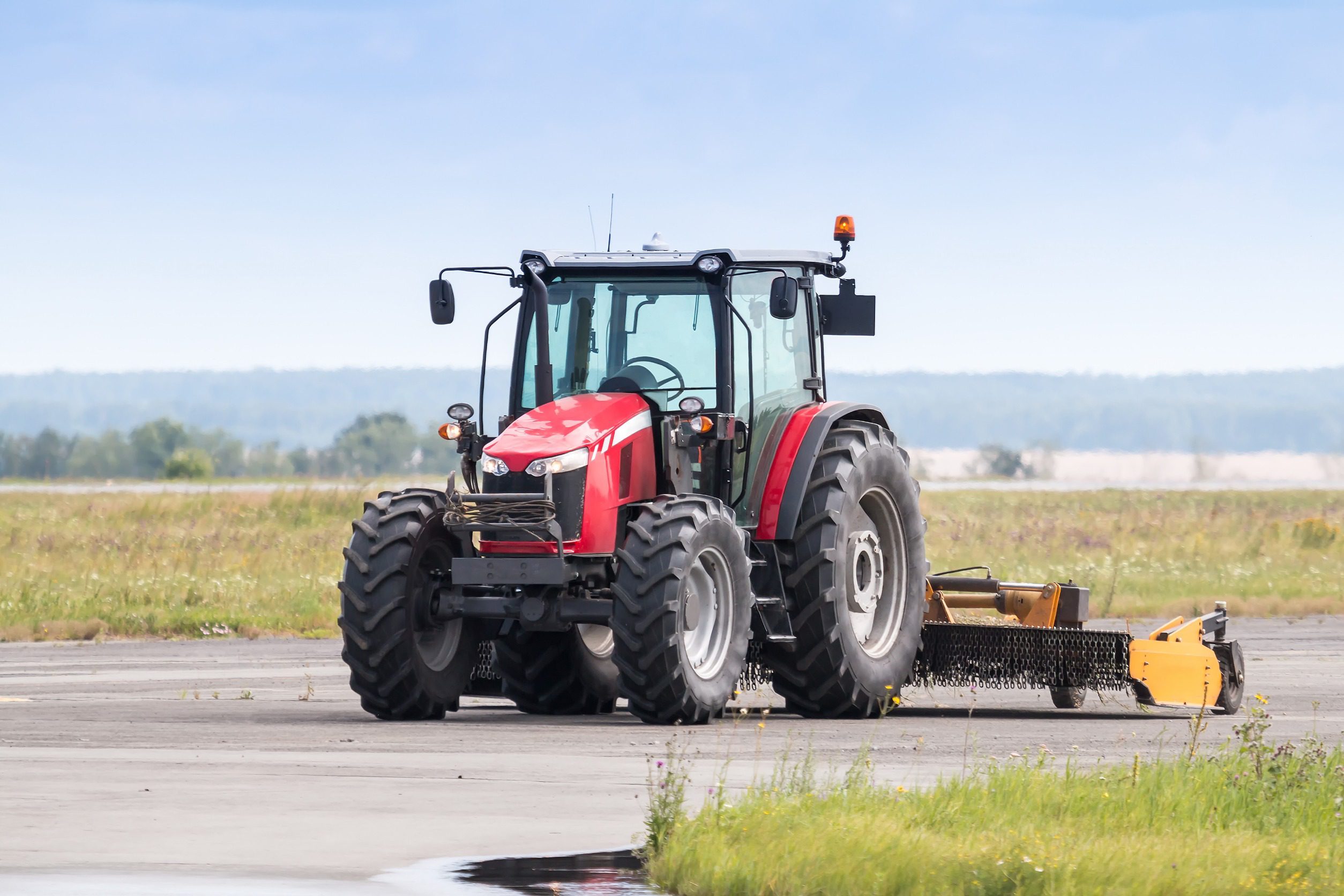 Wheel tractor with lawn mower on the road
